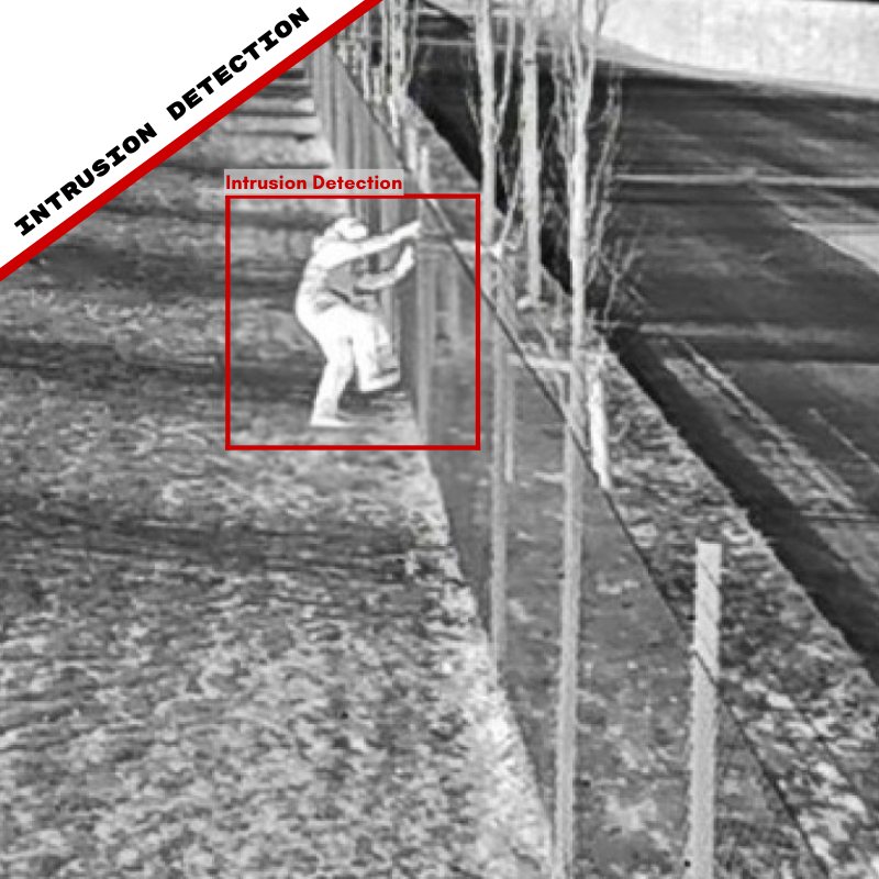 An intruder climbing a perimeter fence detected at night